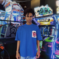 Stylera model wearing a blue unique urban streetwear t-shirt with graphic chest pocket in neon arcade