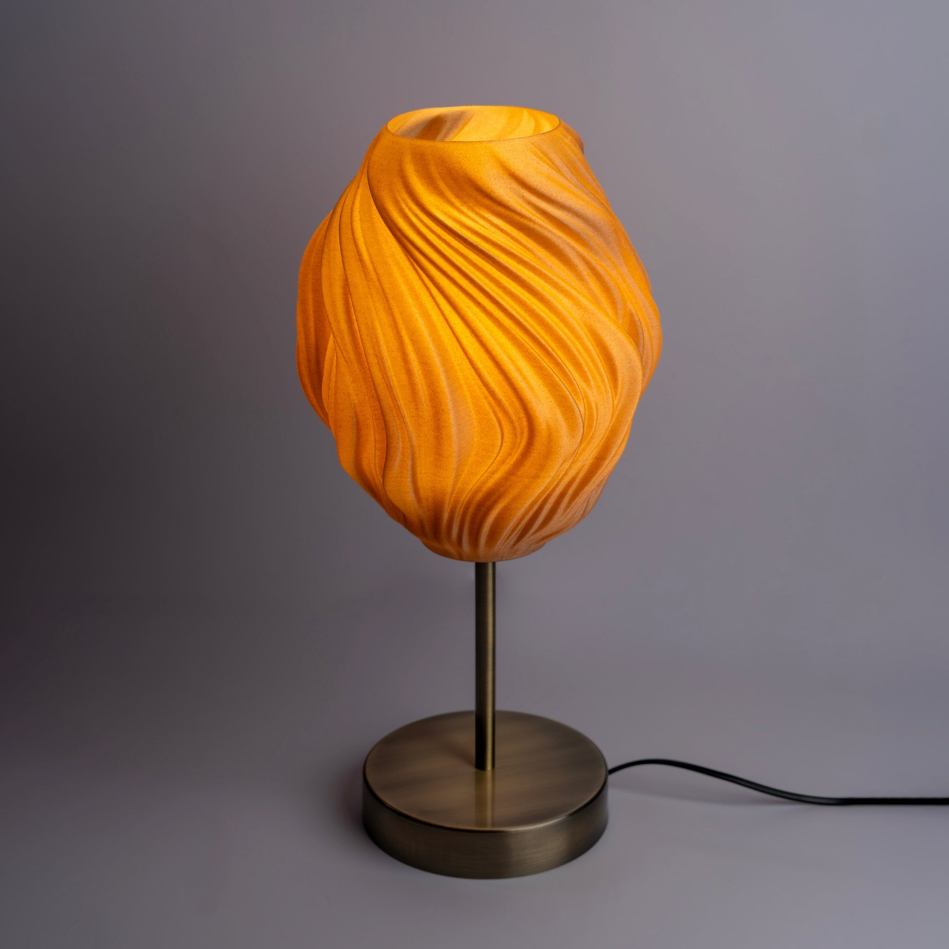 Sozori unique wave pattern desk lamp with a warm orange glow and modern base design