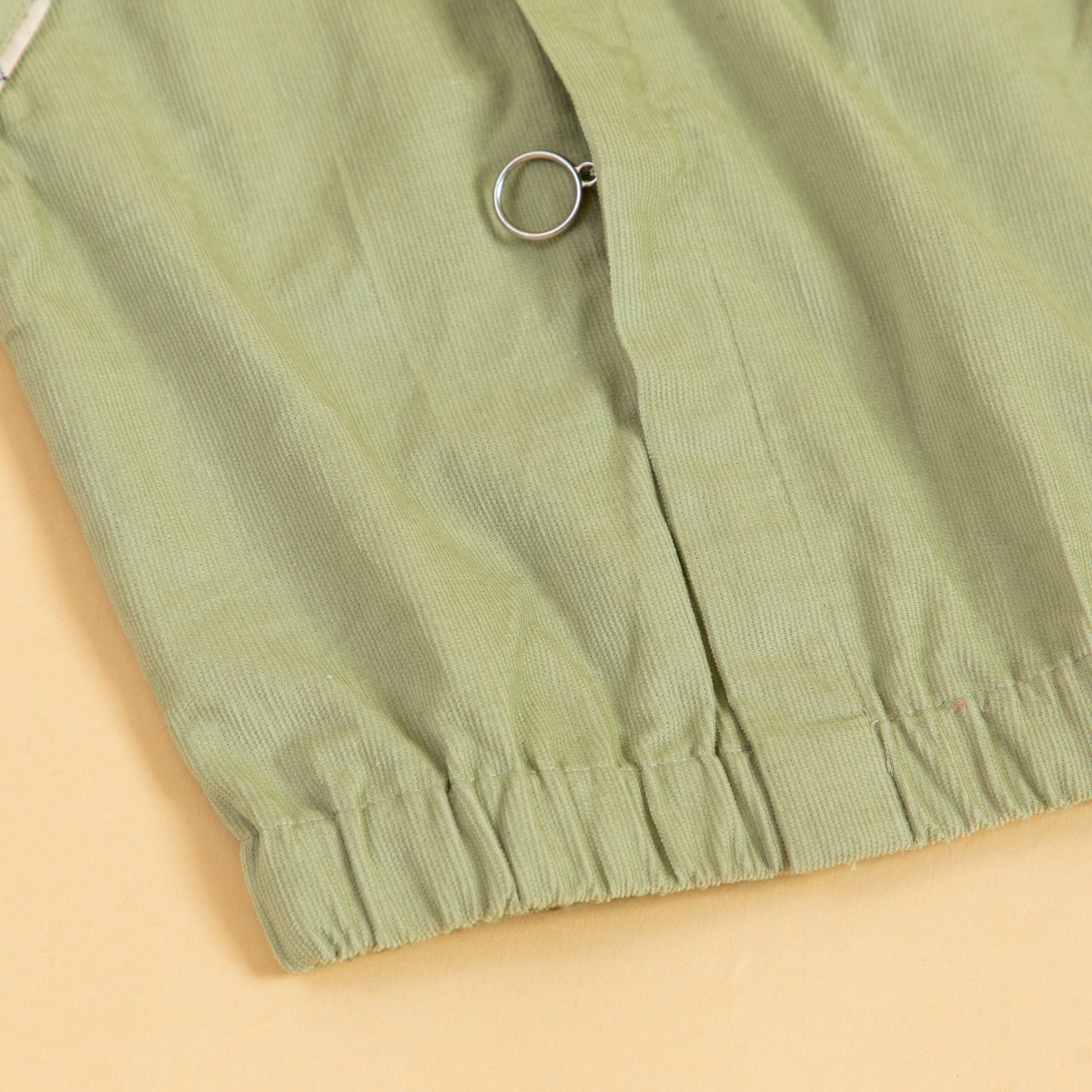 Light green Stylera unisex bomber jacket featuring a comfortable ribbed hem and stylish design