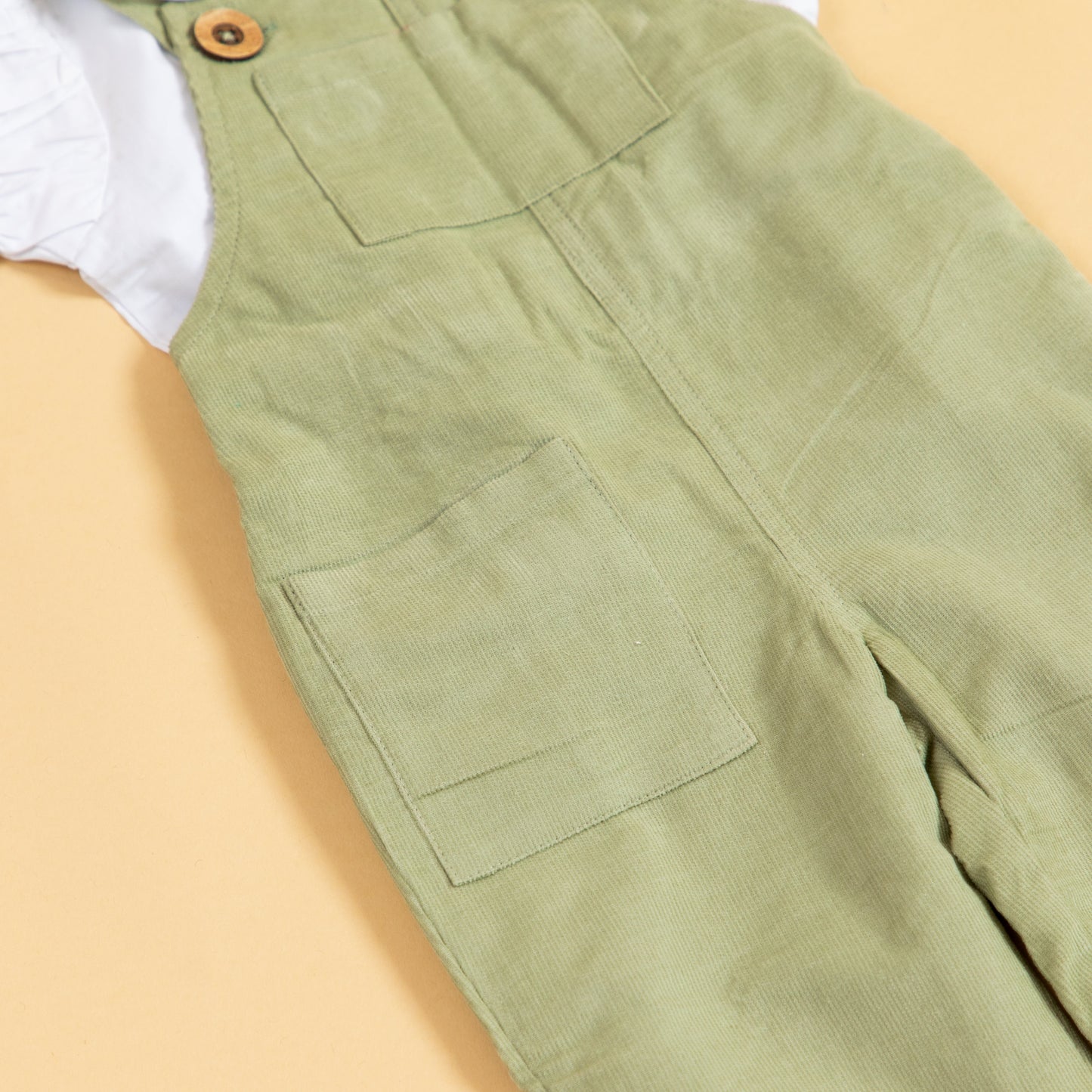 Stylera unisex green dungarees for kids made of soft, durable fabric with pockets