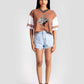 Stylera brown and white graphic tee for women styled with denim shorts and black sneakers