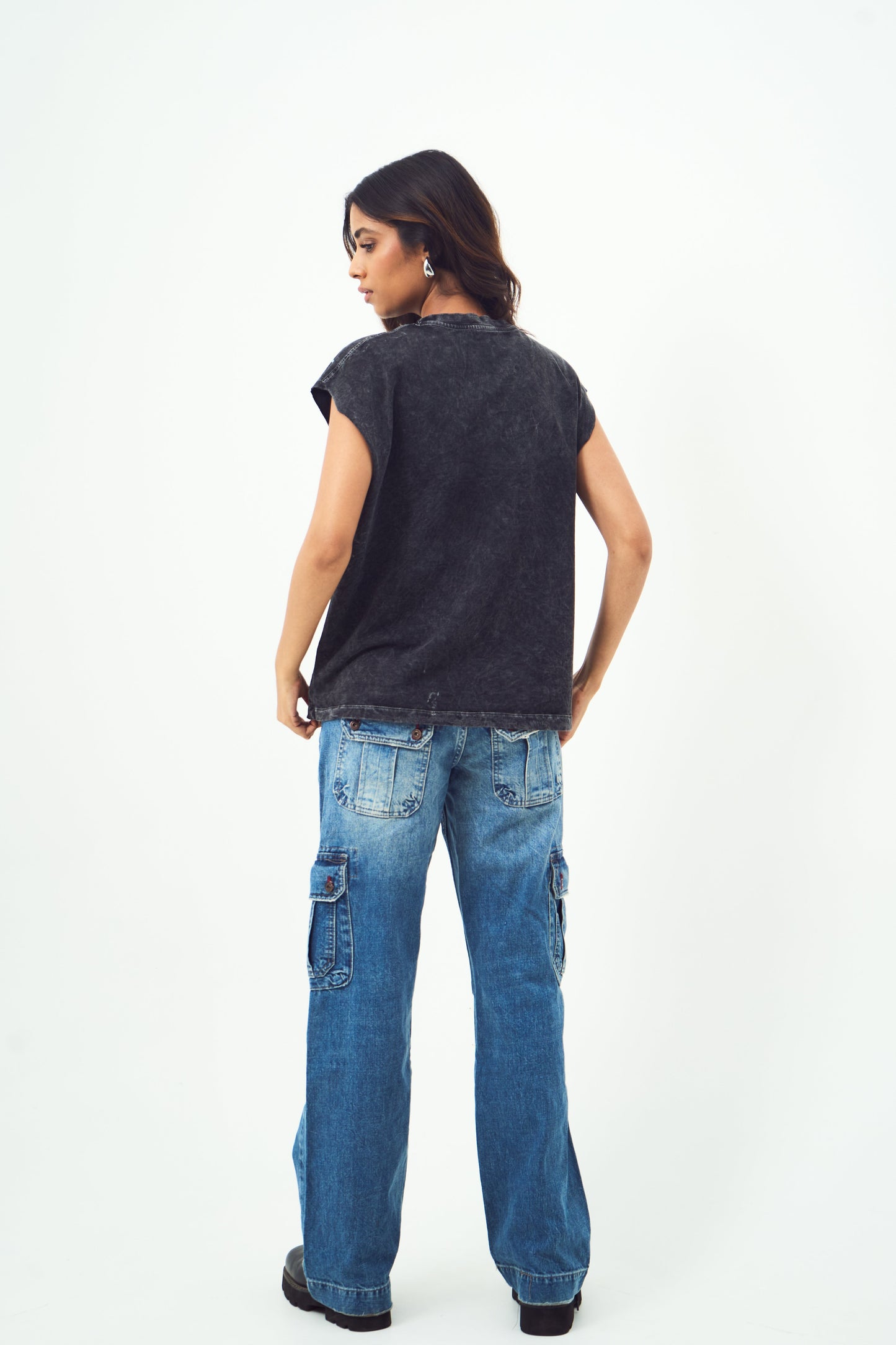 Back view of model wearing Stylera unisex gothic print sleeveless top in washed black with relaxed fit