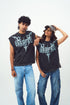 Two models wearing Stylera unisex gothic print sleeveless top in washed black with teal graphic and jeans
