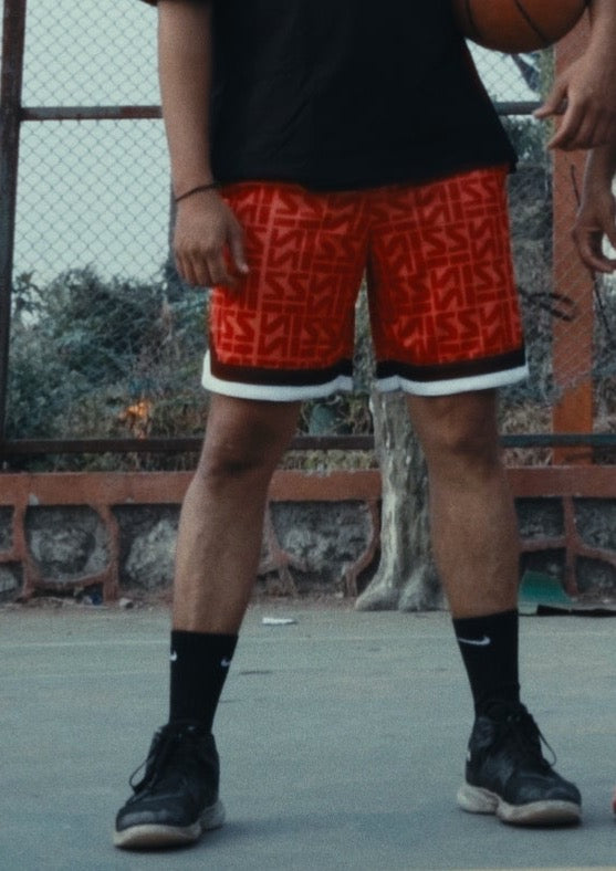 Stylera red patterned shorts with white trim on player on outdoor court trendy basketball shorts for men