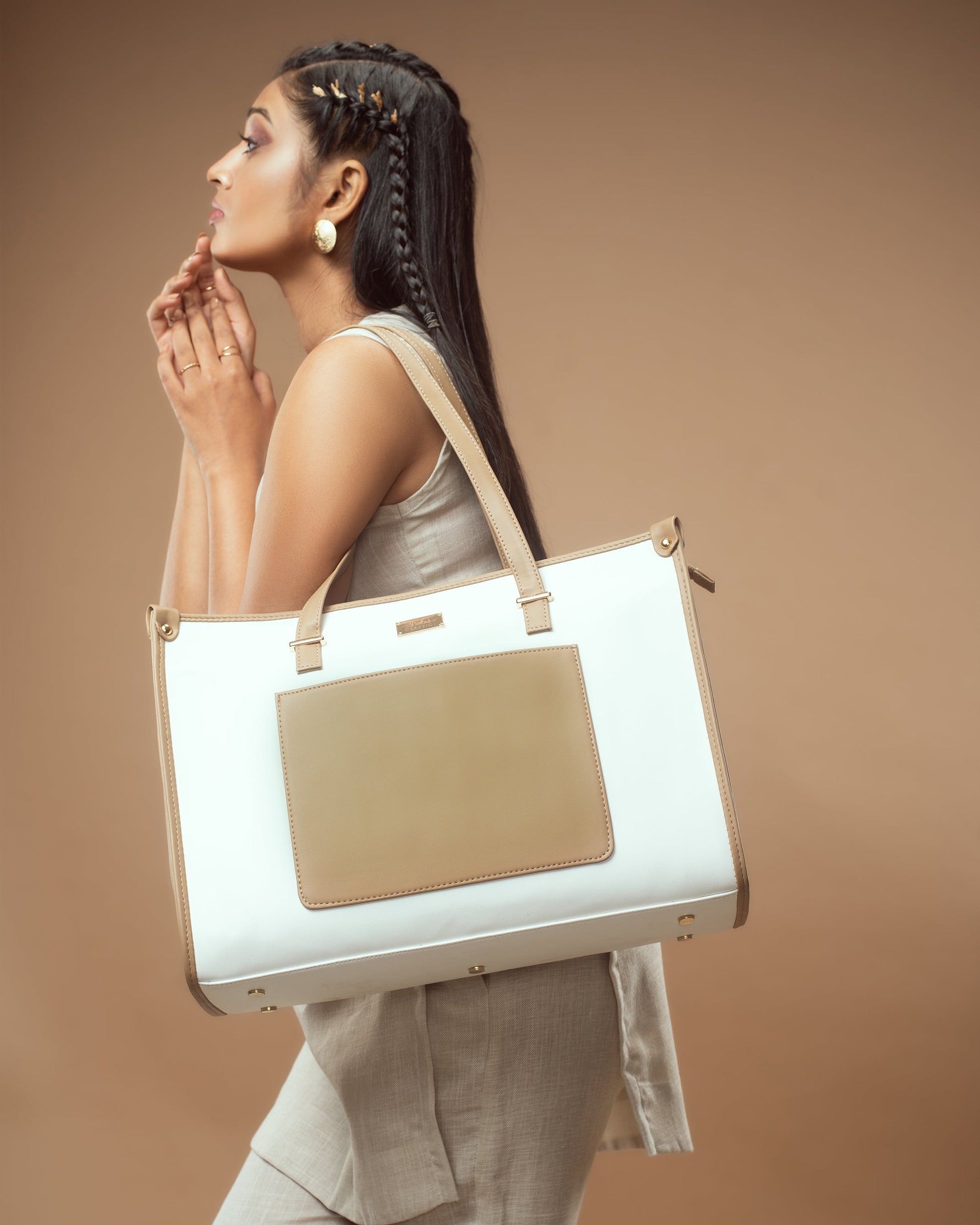 Woman carrying a vanilla taupe box tote bag with elegant design and spacious interior