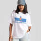 Stylera good vibes only graphic tee for women in white with blue and orange print styled with denim cap and ripped jeans