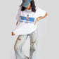 Stylera good vibes only graphic tee for women worn with ripped jeans and denim cap