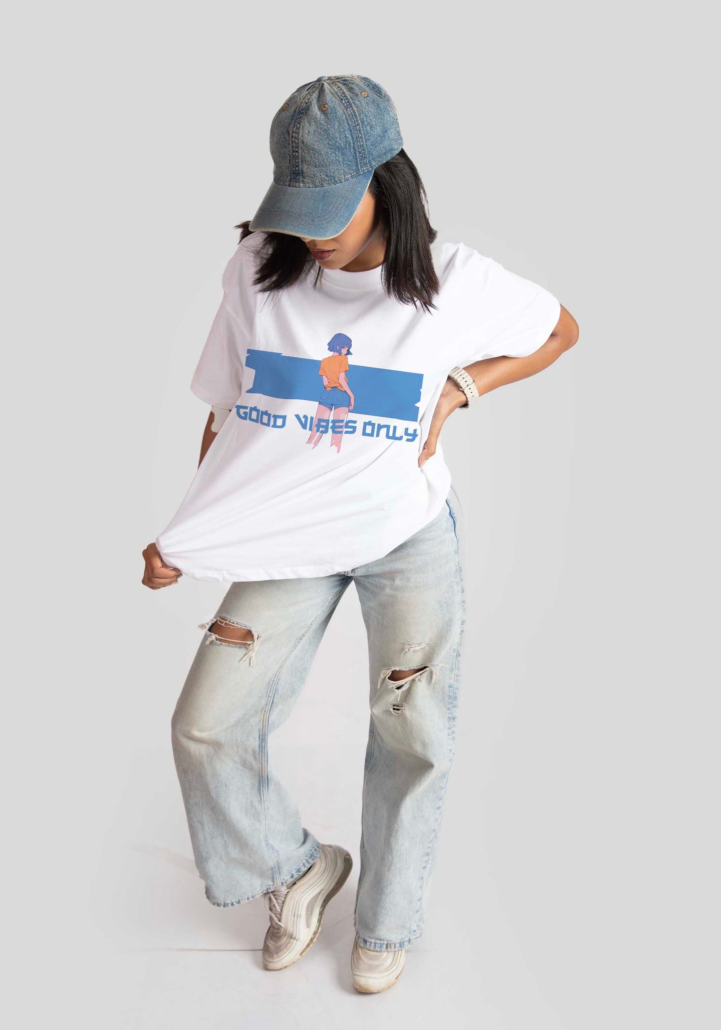Stylera good vibes only graphic tee for women worn with ripped jeans and denim cap