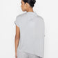 Stylera light gray statement top with asymmetrical hem and relaxed fit on model back view
