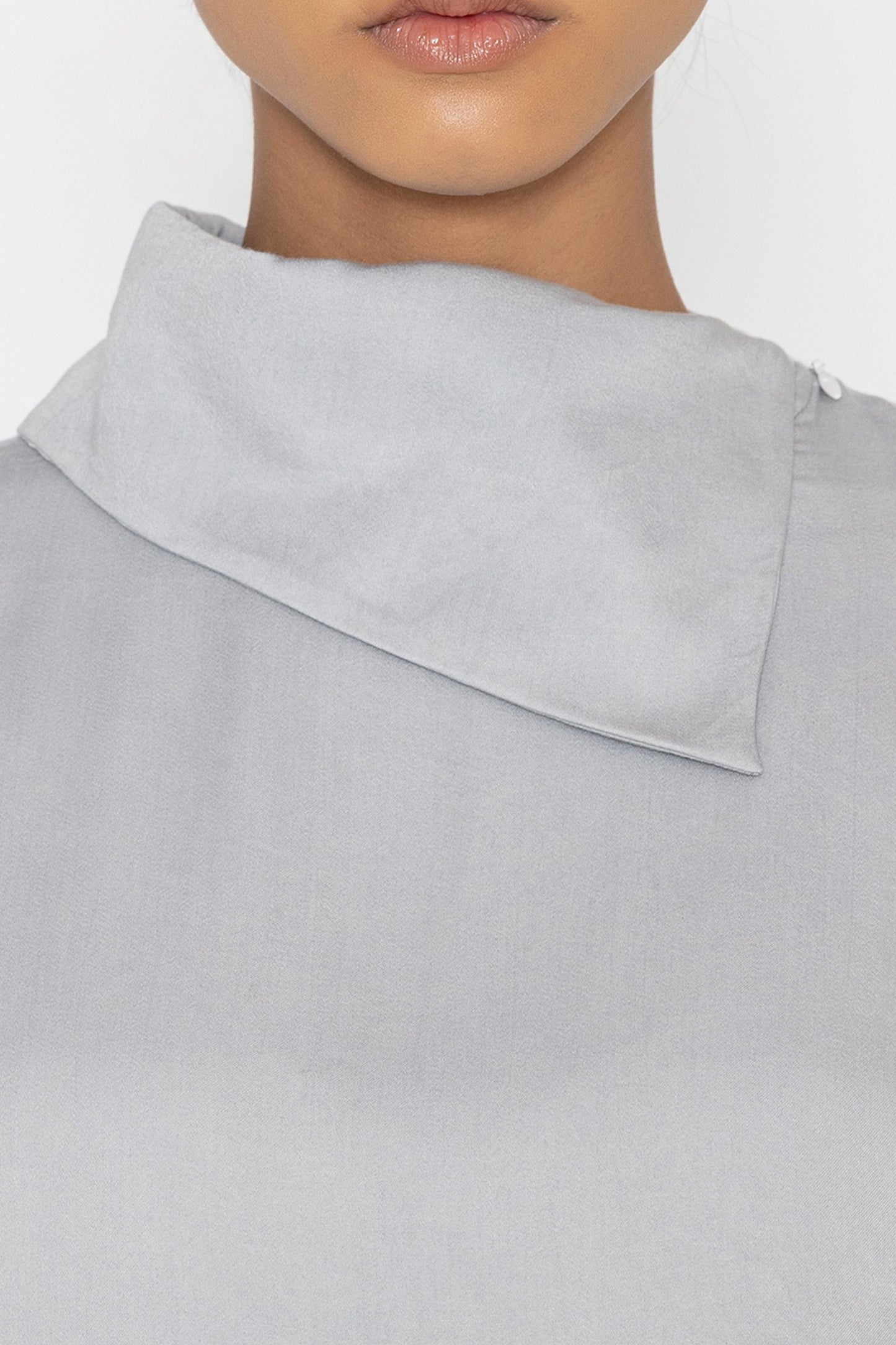 Stylera light gray statement top with unique asymmetrical collar detail close-up