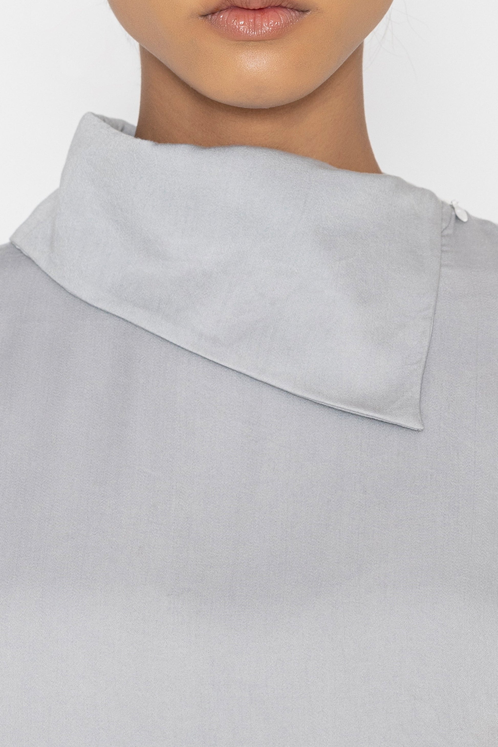 Stylera light gray statement top with unique asymmetrical collar detail close-up