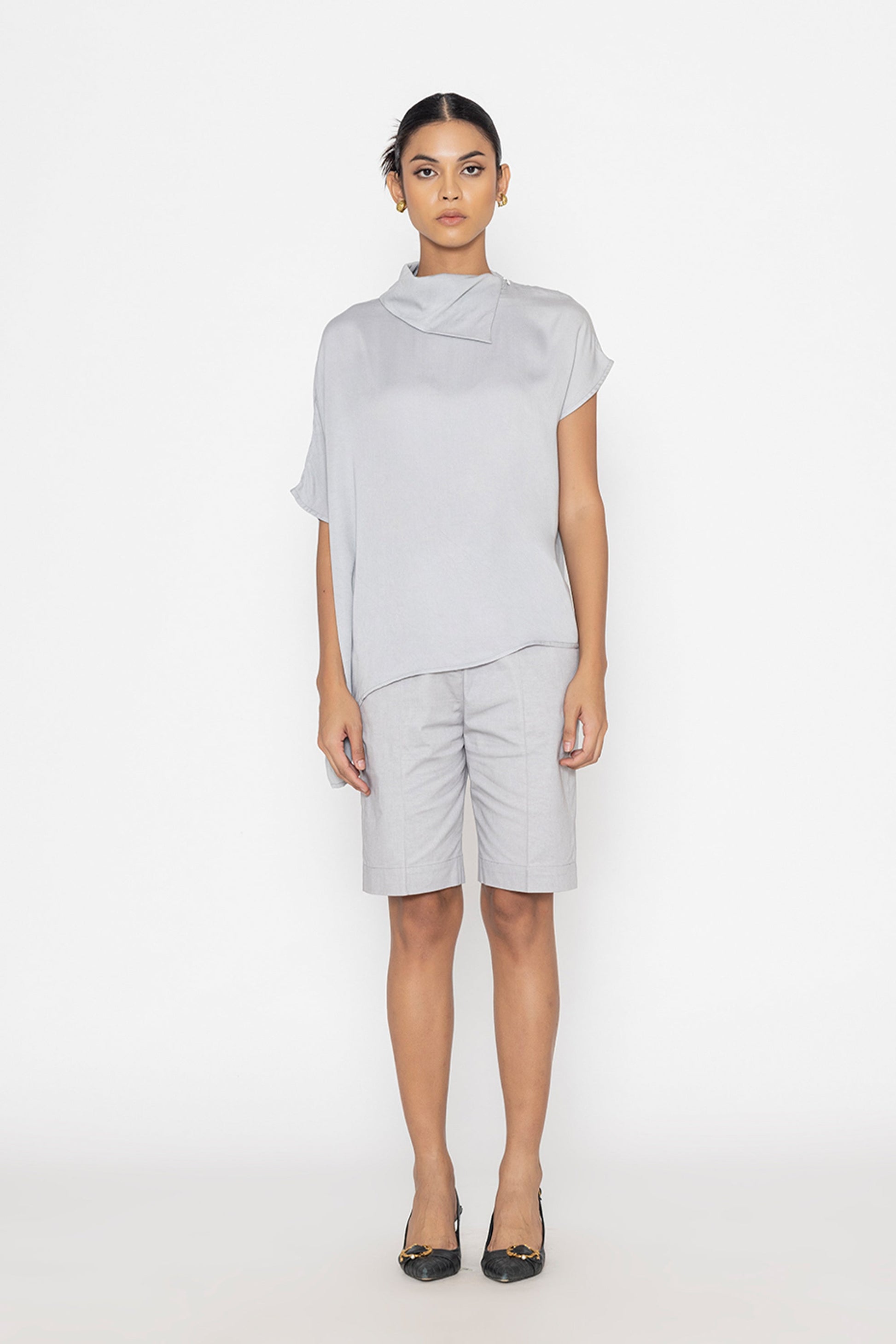 Stylera light gray statement top with high neck and short sleeves styled with matching shorts