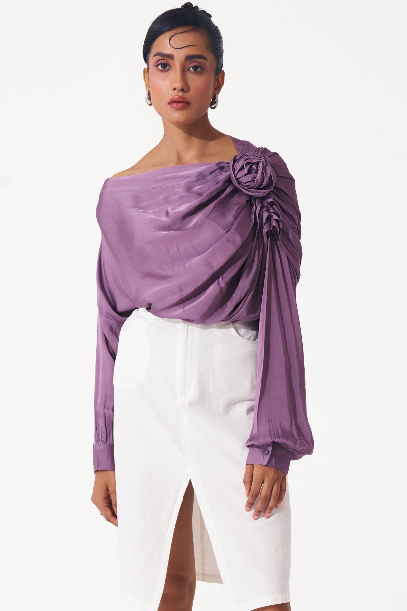 Stylera purple draped evening top with off-shoulder design and floral detail paired with white skirt
