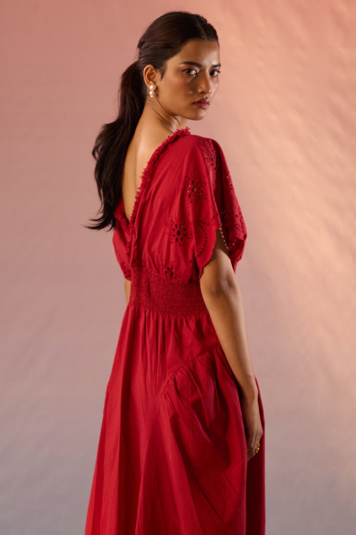 Stylera red Schiffli maxi dress with detailed embroidery and open back design on model