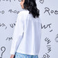 Woman wearing Stylera sequin heart shirt white long sleeve back view