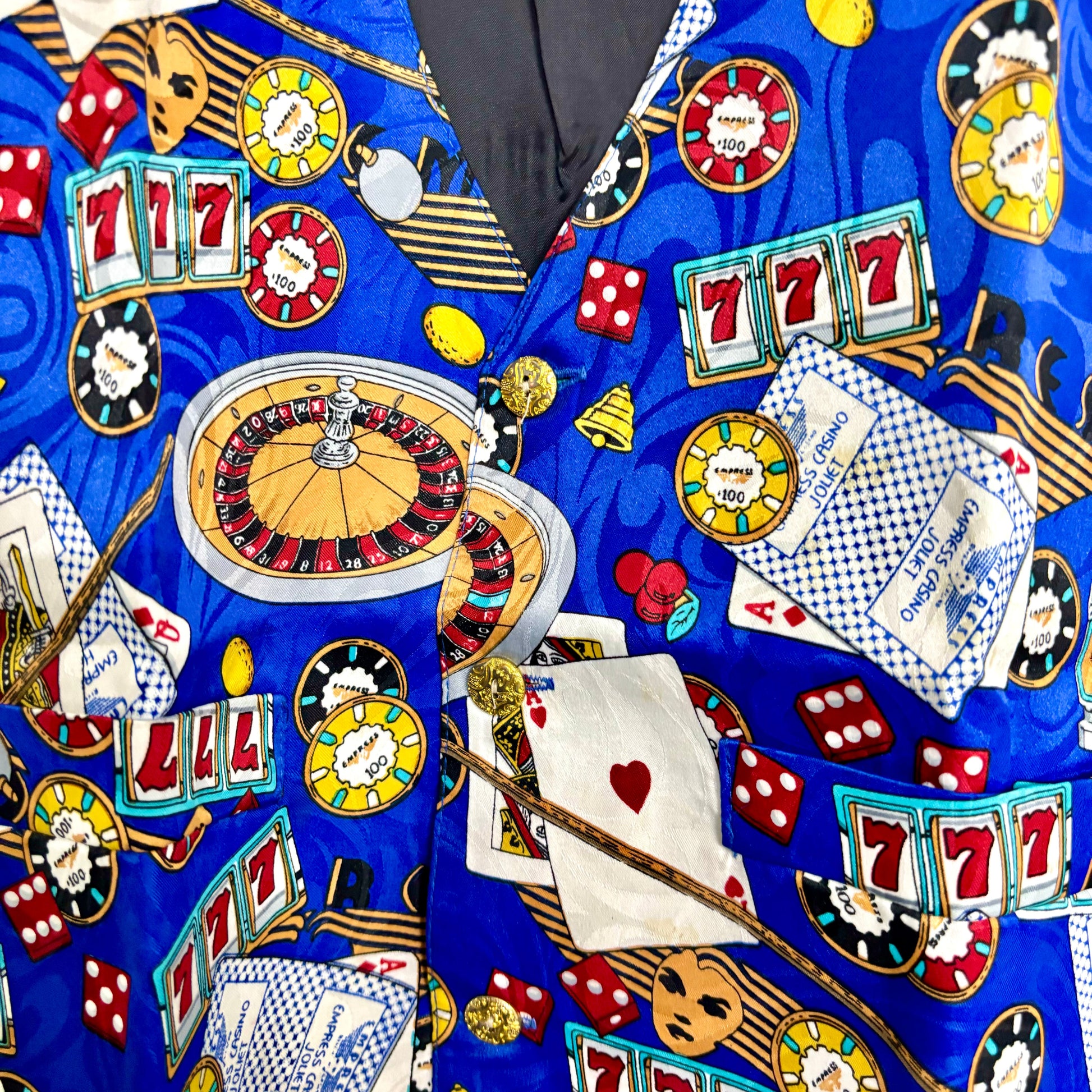 Blue novelty casino print vest with roulette wheel 777 slots poker chips dice and playing cards