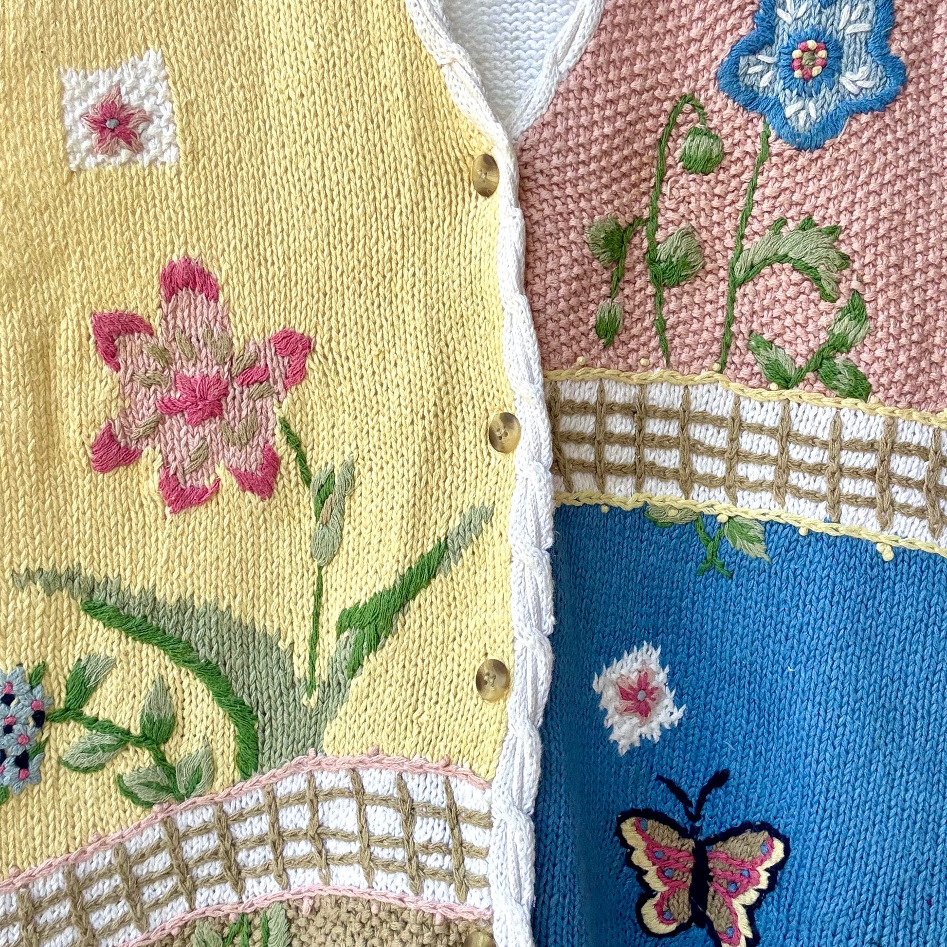 colorful knit vest for women patchwork closeup with yellow pink blue panels floral and butterfly embroidery