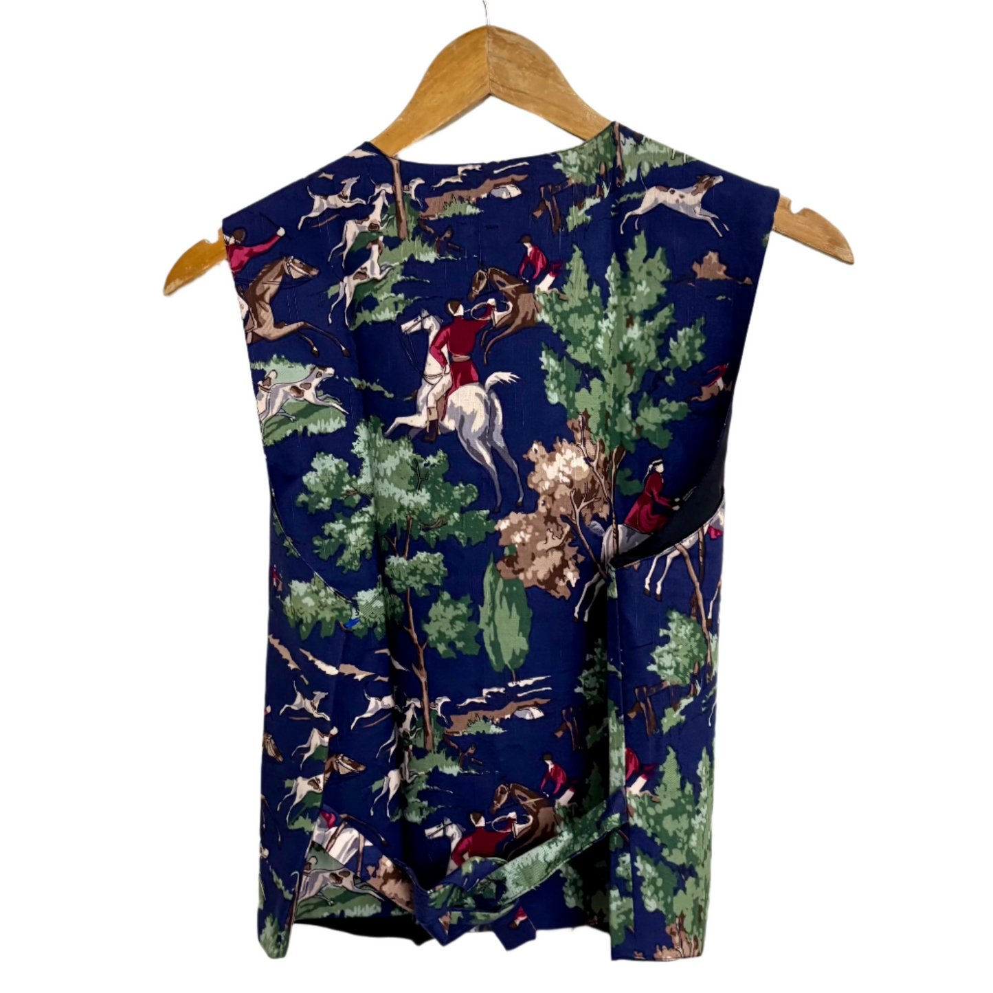Blue equestrian print vest on wooden hanger showing hunting scene with trees colorful patterned vest for layering by Stylera 