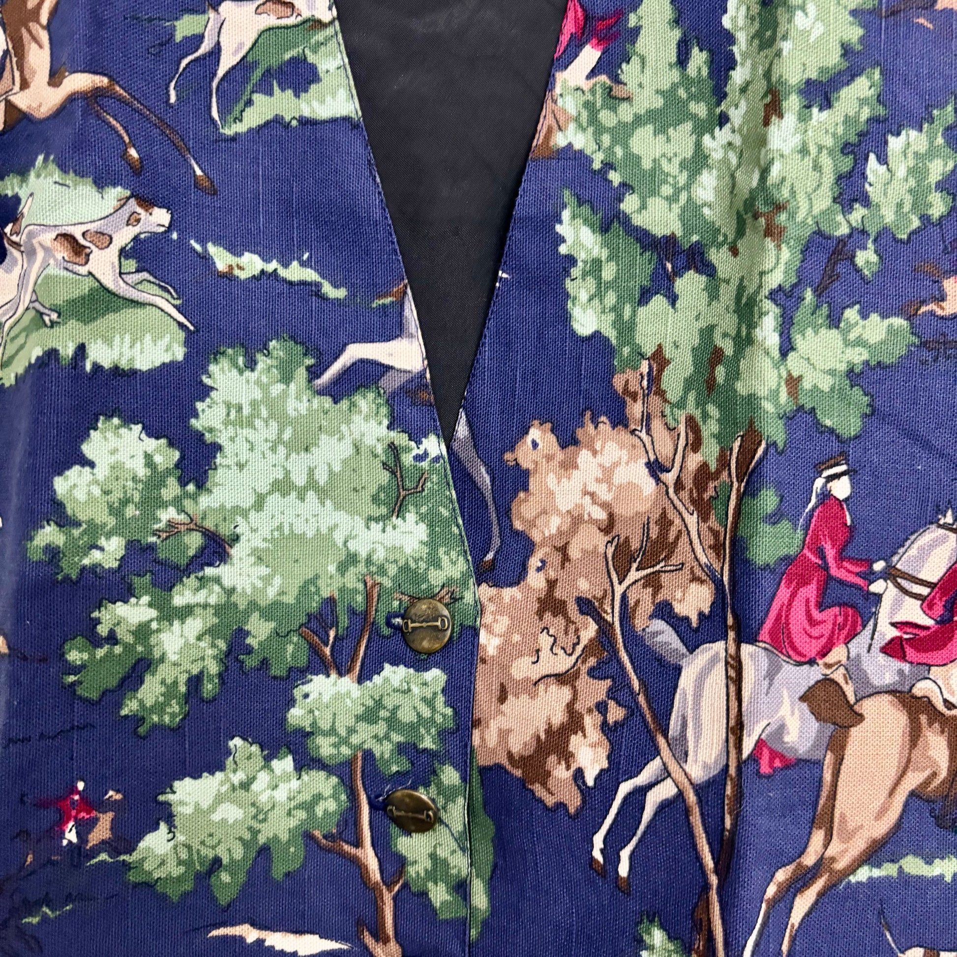 colorful patterned vest for layering featuring equestrian hunting scene print on navy fabric with brass buttons