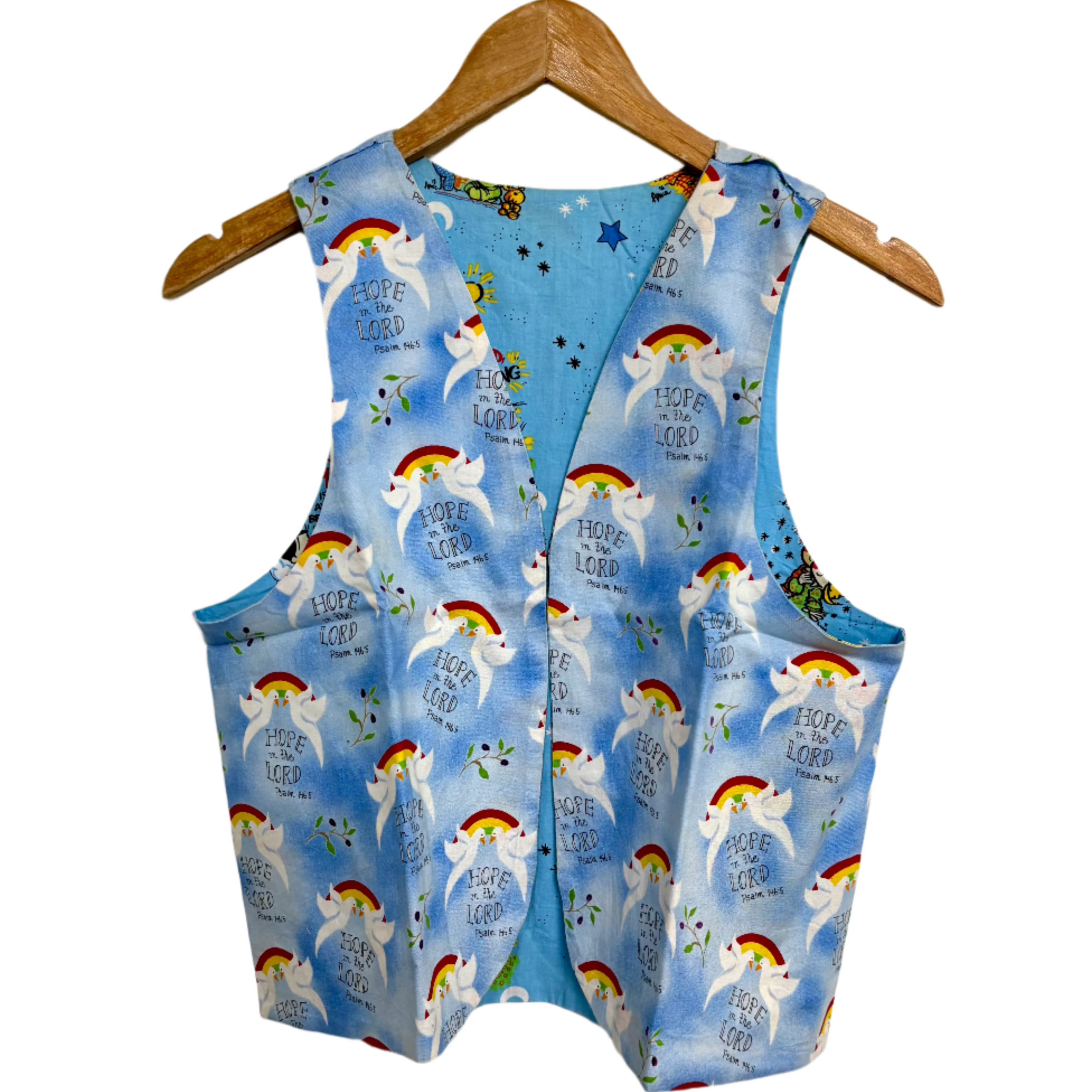 Blue printed Hope in the Lord reversible vest with rainbow and dove pattern hanging on wooden hanger