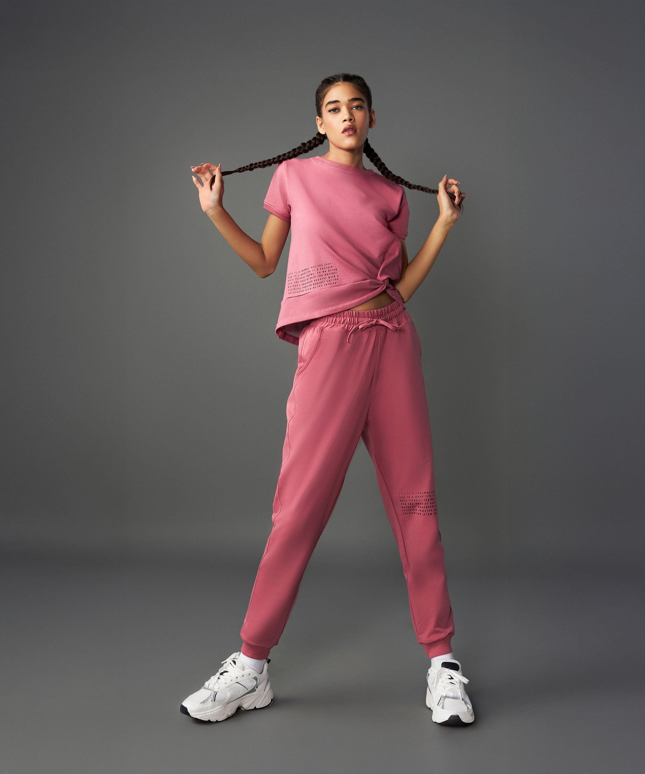 Stylish model showcasing a vintage pink co-ord set with a relaxed fit top and matching joggers