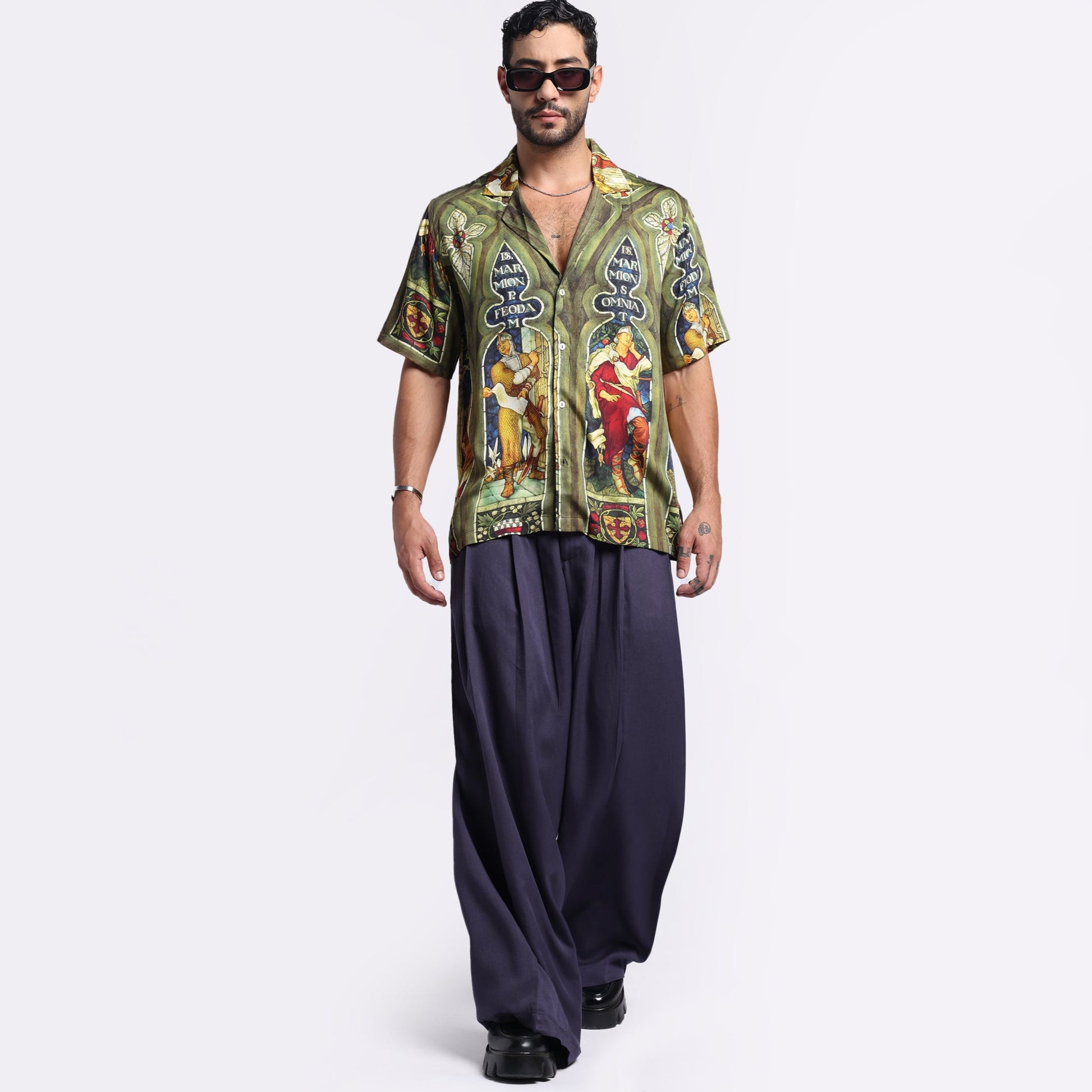 Stylera vintage print button up shirt worn by a model with stylish sunglasses and wide-leg pants