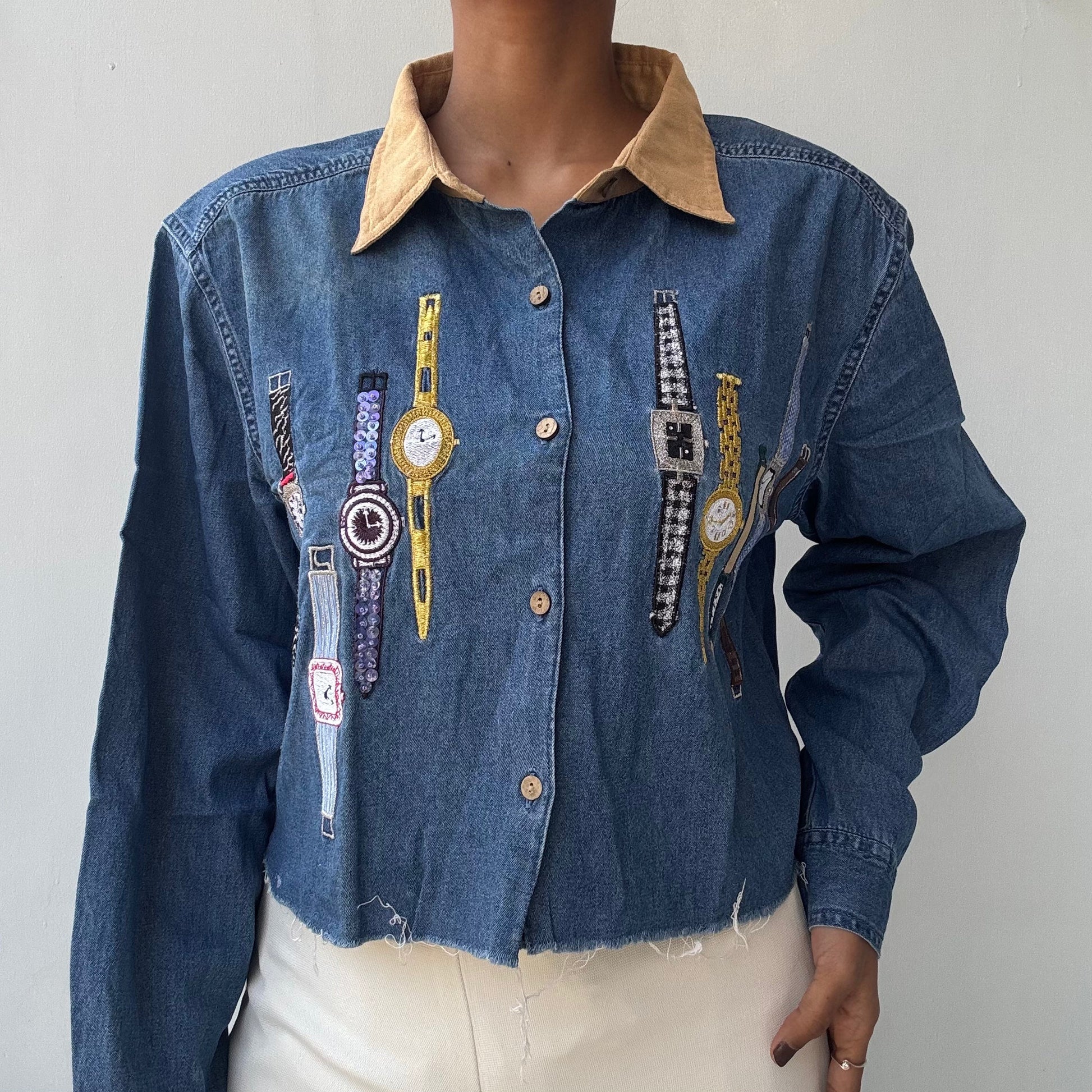 trendy cropped denim jacket with embroidered wristwatch motifs tan corduroy collar frayed hem button front