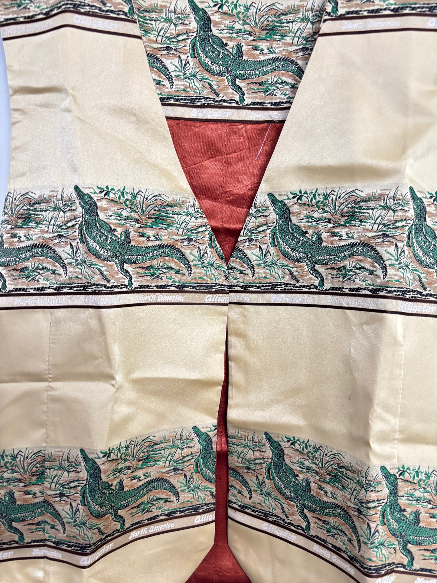 Beige and green unique animal print vest with reptile border pattern and red satin lining from Stylera