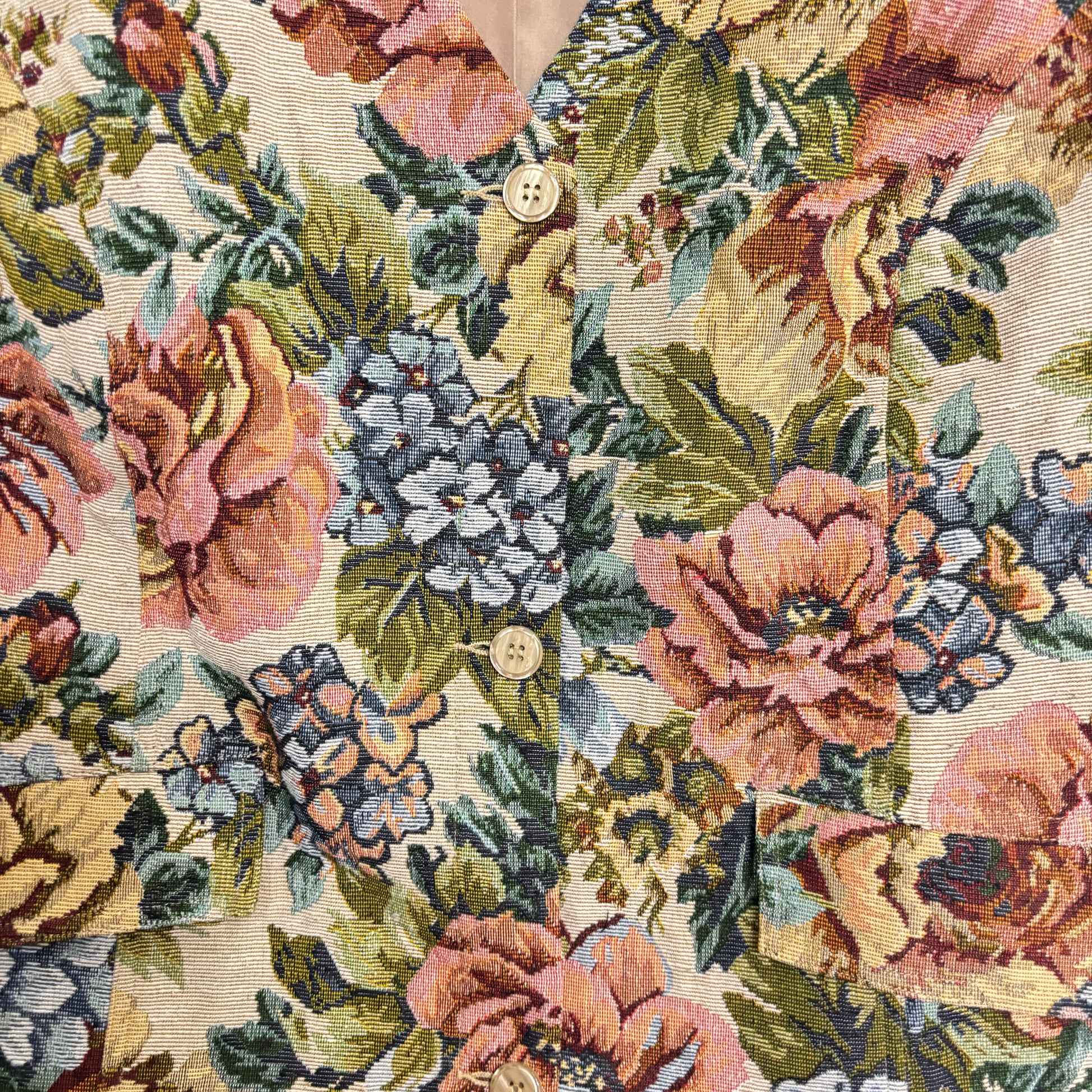 Close up of Stylera women's floral statement vest in vintage tapestry print with wooden buttons and pockets
