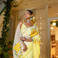 Elegant wedding organza saree yellow with floral patterns, ideal for festive occasions and celebrations