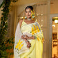 Elegant wedding organza saree yellow with floral print, styled with jewelry for festive events