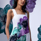 Model wearing white coral floral jumpsuit by Stylera with watercolor purple and teal floral print