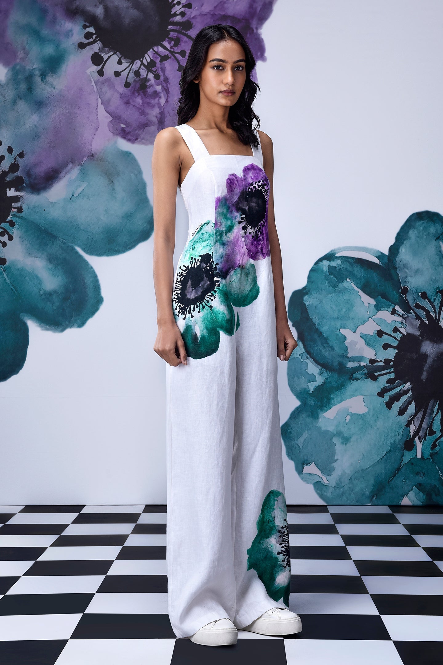 Model wearing Stylera white coral floral jumpsuit wide leg dungaree with bold teal and purple floral print