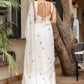 Elegant white cotton saree with tassels featuring colorful accents, perfect for casual or festive occasions