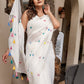 Elegant white cotton saree with tassels featuring colorful polka dots, perfect for festive occasions