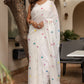 Elegant white cotton saree with tassels and colorful pom-pom accents for a stylish look