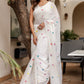 Elegant white cotton saree with tassels and colorful embroidery, perfect for festive occasions