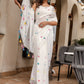 Elegant white cotton saree with tassels and colorful pom-poms, perfect for festive occasions