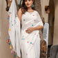 Elegant white cotton saree with tassels and colorful embroidery for stylish occasions
