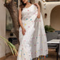 Stylera White Cotton Saree with Tassels adorned with colorful pom-poms for a vibrant look