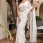 Elegant white cotton saree with tassels, adorned with colorful pom poms for a vibrant look