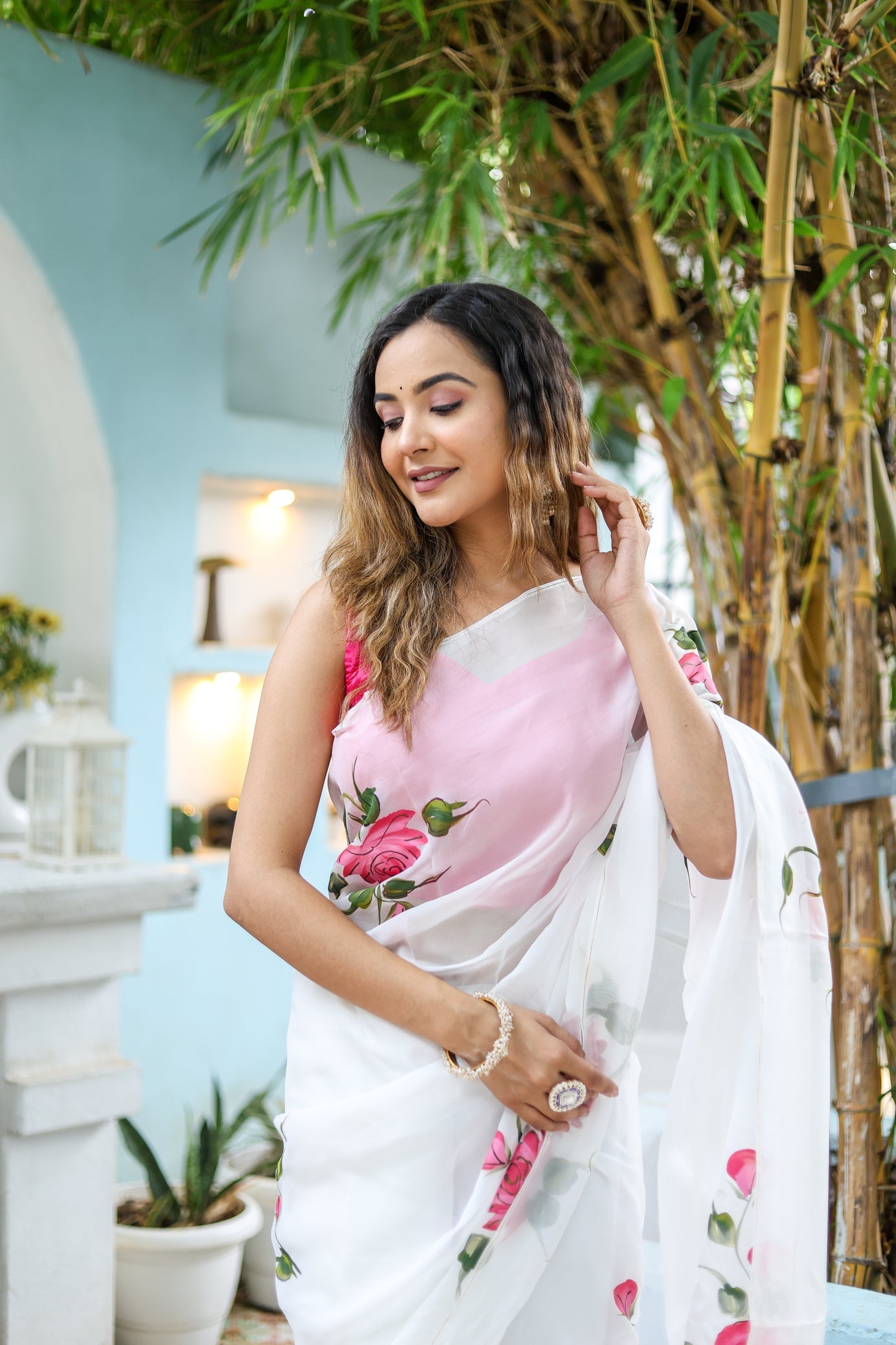 Elegant white floral saree for women featuring pink roses, ideal for festive occasions