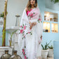 Elegant white floral saree for women featuring pink roses, perfect for special occasions and festive events