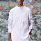 Male model wearing a white linen casual shirt for men with mandarin collar chest pocket and round sunglasses