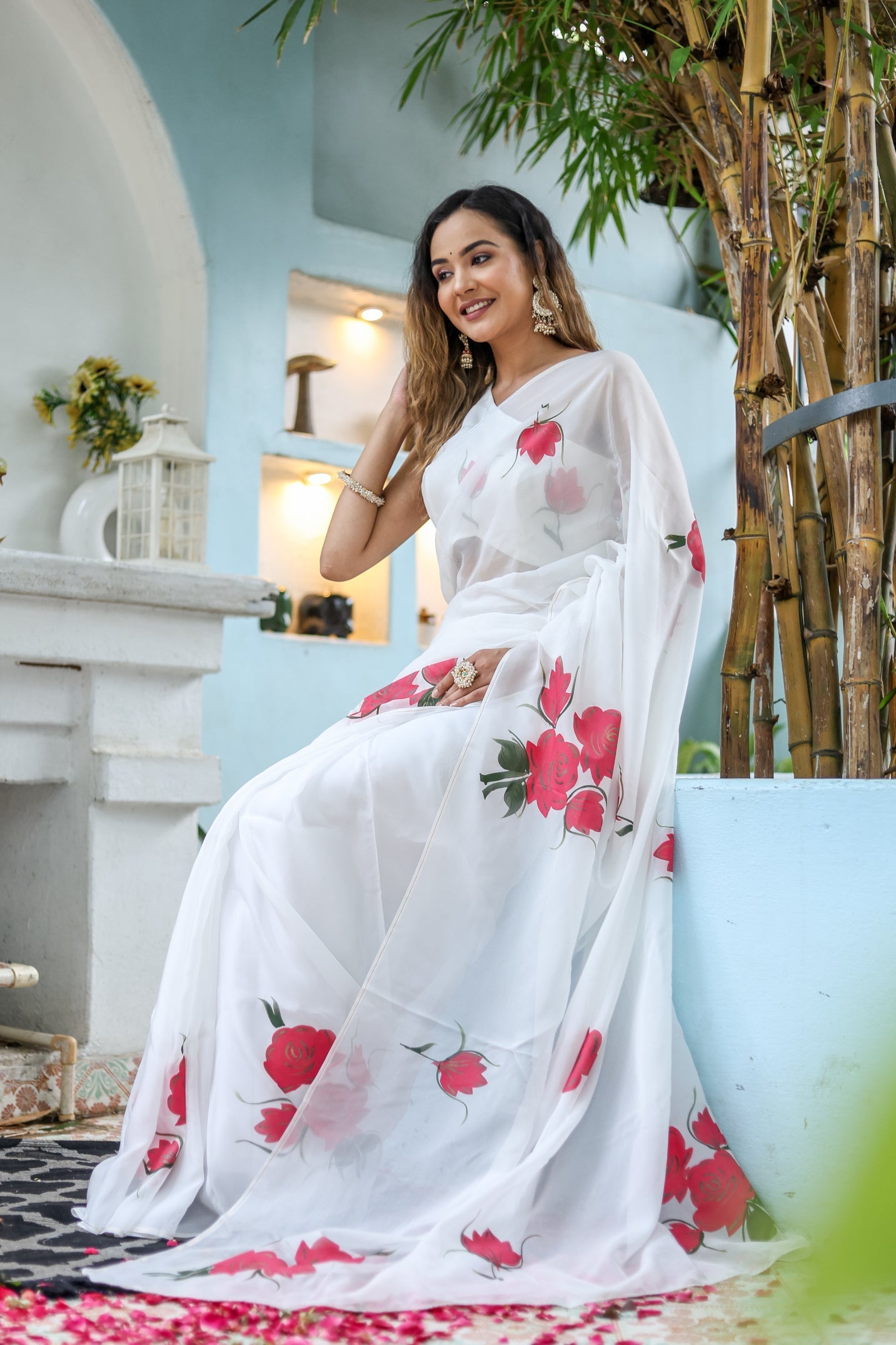 Elegant white organza saree for women with red floral prints, perfect for festive occasions