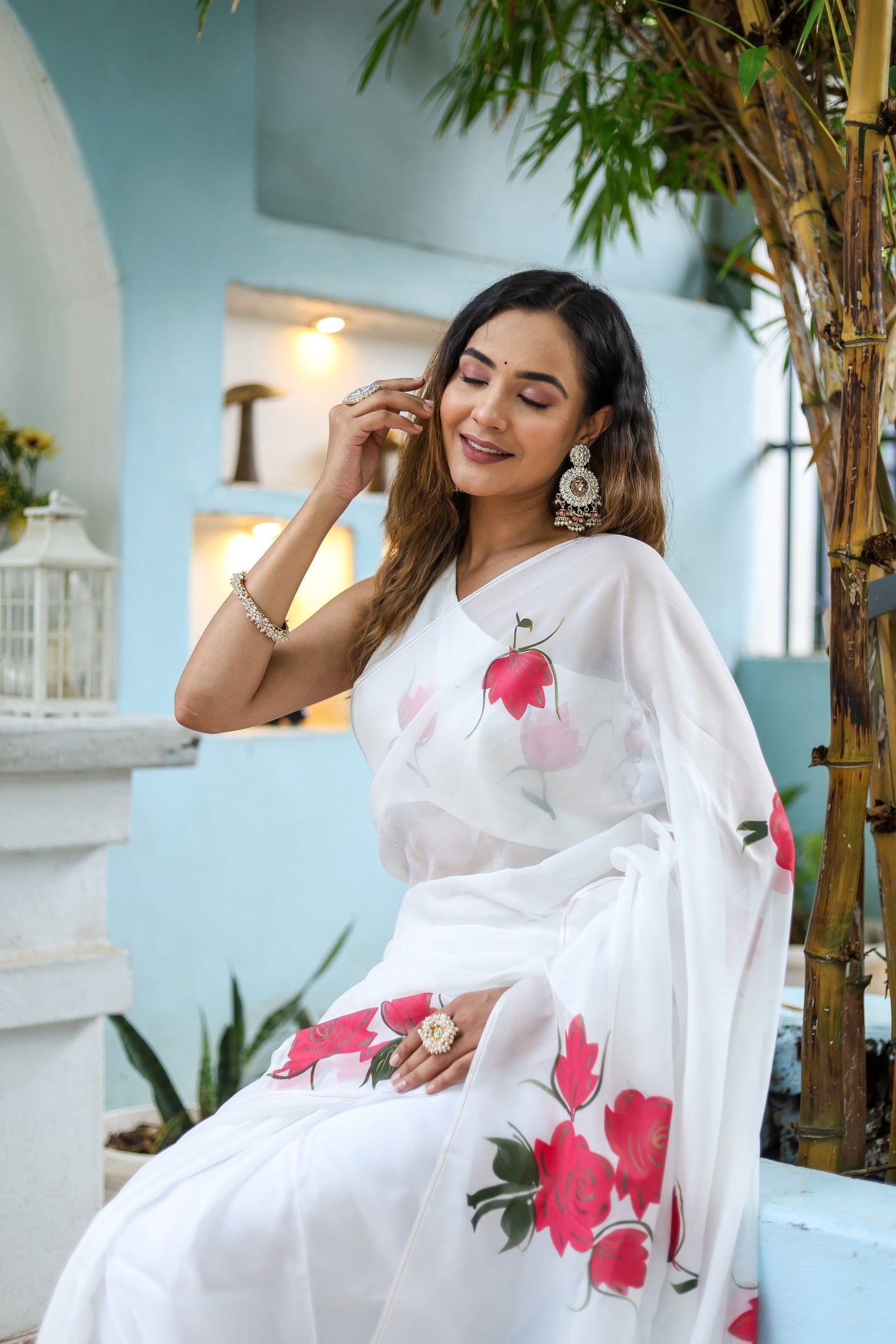 Elegant white organza saree for women featuring floral designs, perfect for festive occasions