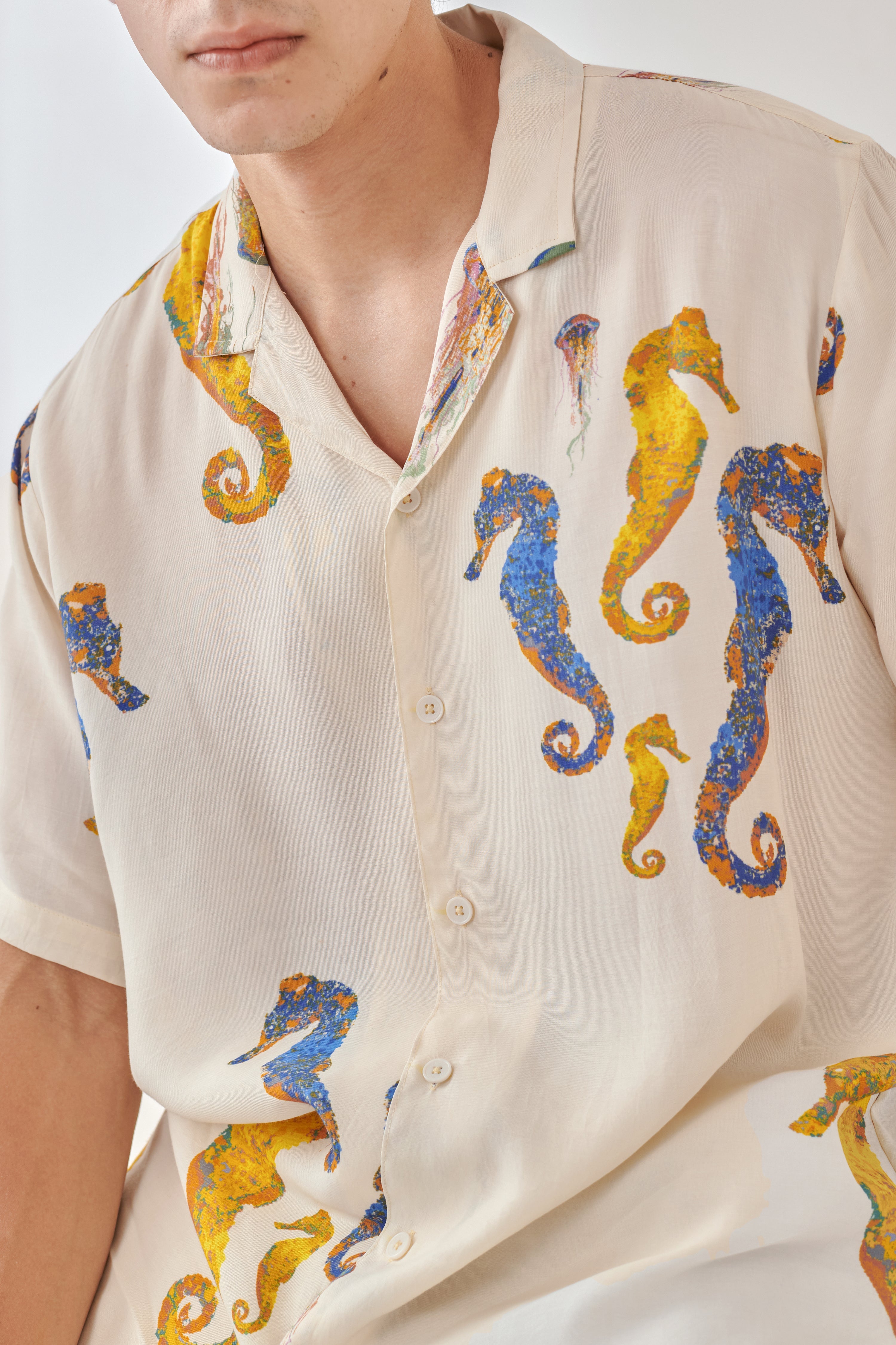White oversized beach shirt men featuring colorful seahorse print for a relaxed summer look