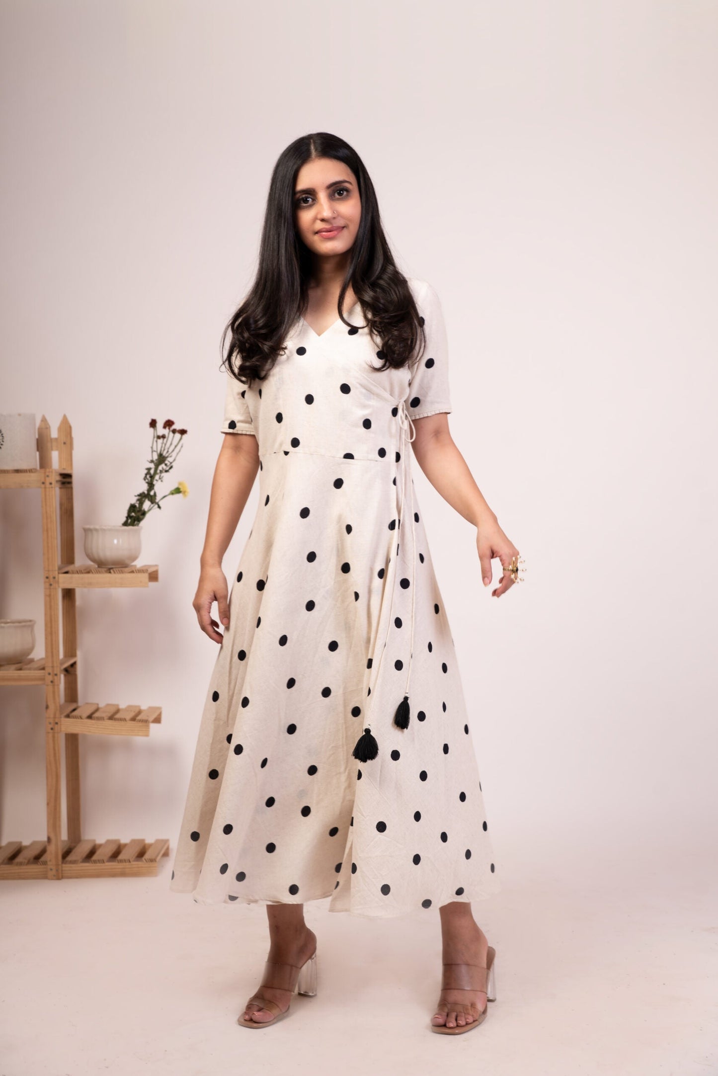 Elegant white polka dot dress for women with a wrap design and tassel details