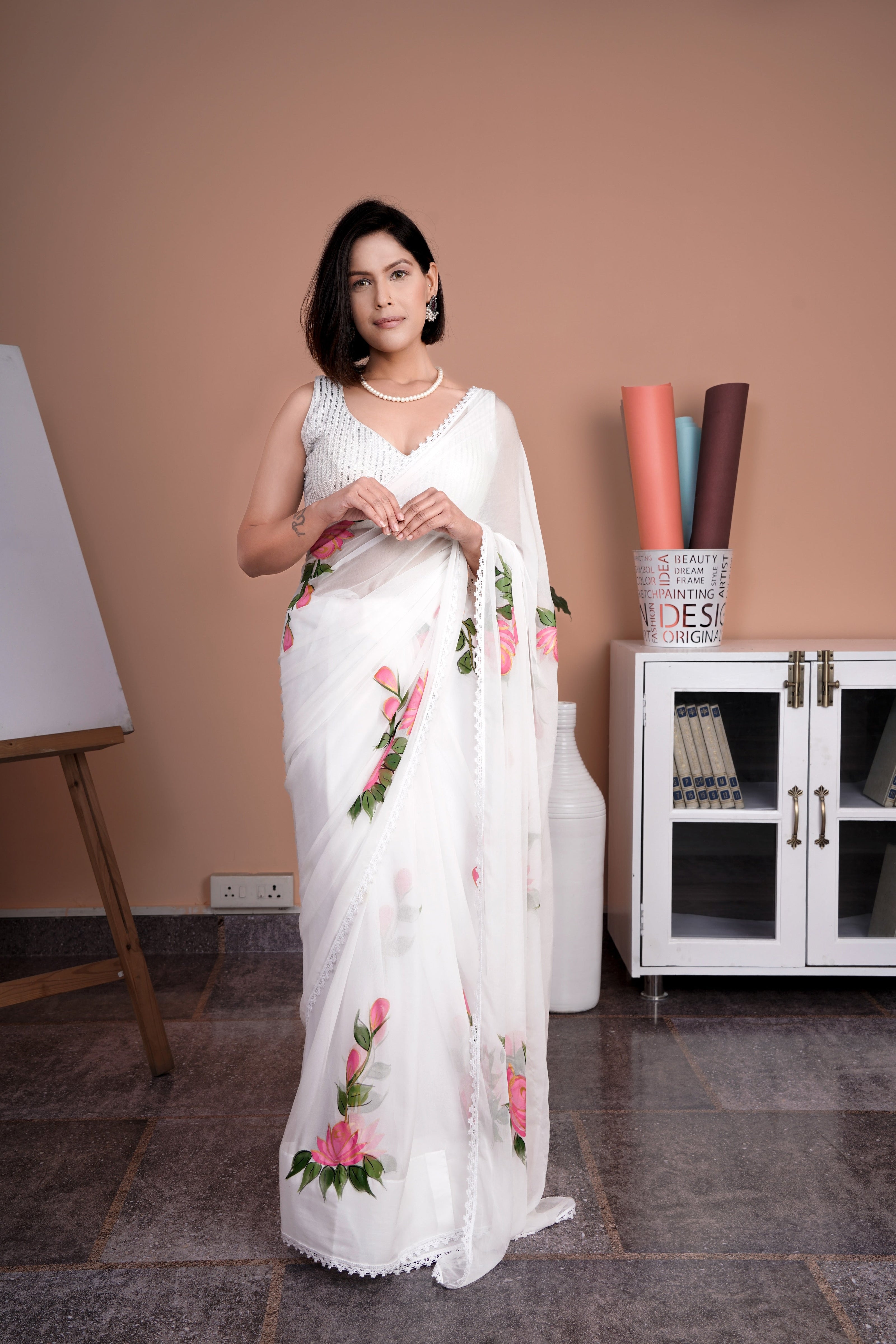 Elegant white saree with pink floral print, perfect for special occasions and celebrations