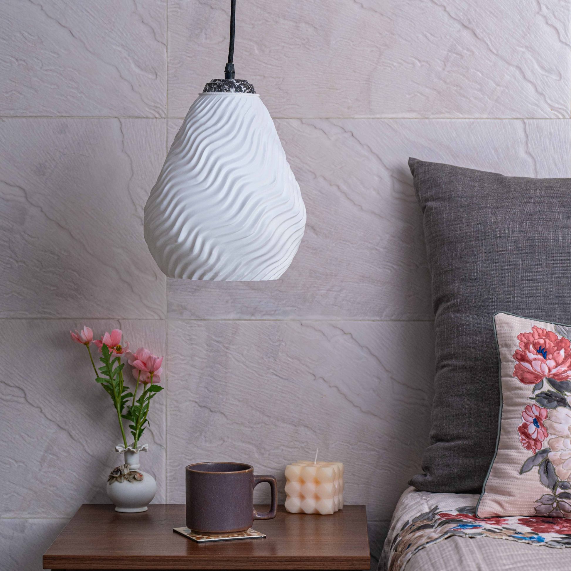 Sozori white sculptural hanging light adding elegance to a cozy bedroom decor